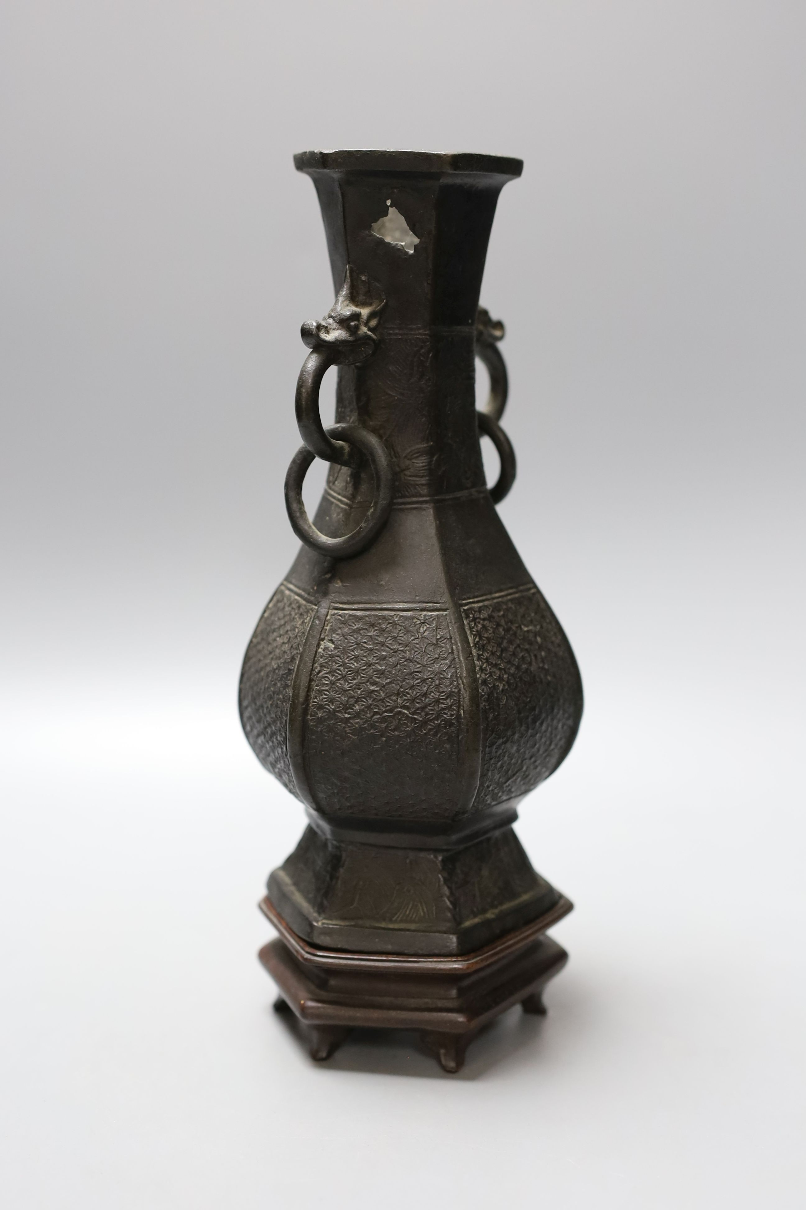 A Chinese bronze vase with ring handles, Song/Yuan Dynasty, on hardwood stand, 24cm total height